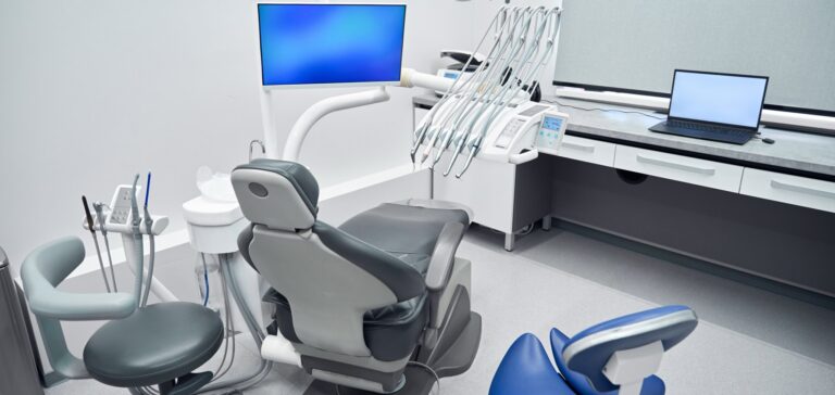Modern dental operatory with chair, monitor and laptop